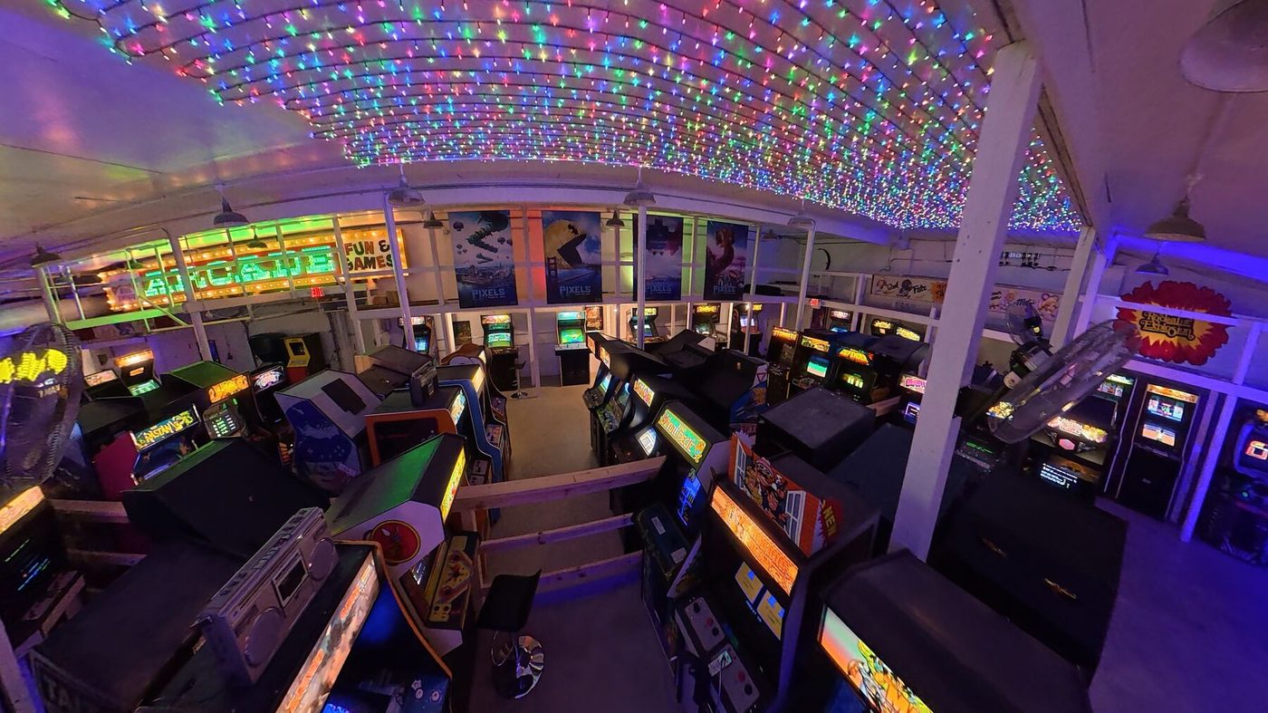 The arcade floor under a canopy of colored lights